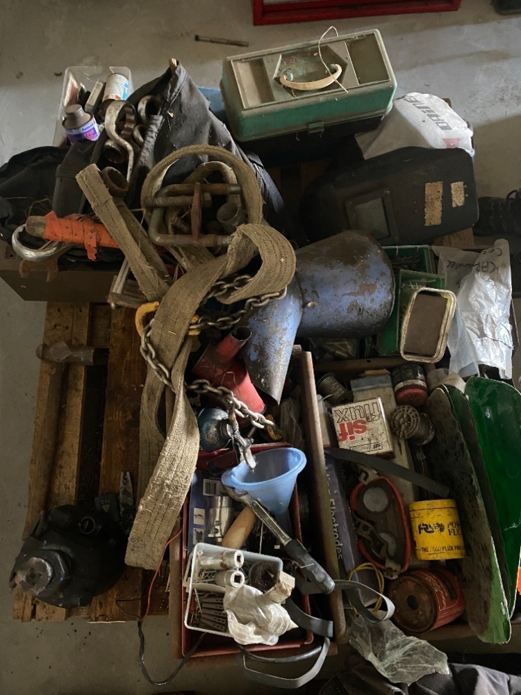 Pallet of miscellaneous work shop items incl.. welding rods and masks, bottle jack, large spanners, oil cans, various tools nails and screws